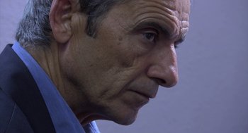 Movie still from “The Secret of the Grain” (2007), directed by Abdellatif Kechiche – An older man looking to his left with an intense look on his face; Close Up shot, Low angle