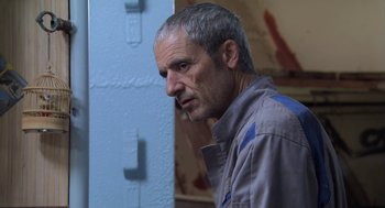 Movie still from “The Secret of the Grain” (2007), directed by Abdellatif Kechiche – A person with a cigarette in his mouth; Close Up shot, Over the shoulder angle