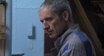 Movie still from “The Secret of the Grain” (2007), directed by Abdellatif Kechiche – A person wearing a jacket; Close Up shot, Low angle