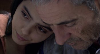 Movie still from “The Secret of the Grain” (2007), directed by Abdellatif Kechiche – An older man and a younger woman looking at one another; Close Up shot, Over the shoulder angle