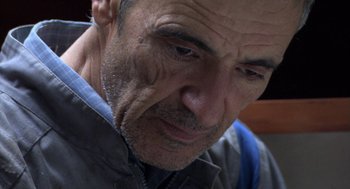 Movie still from “The Secret of the Grain” (2007), directed by Abdellatif Kechiche – An older man with a sad look on his face; Close Up shot, Low angle