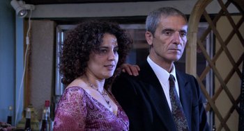 Movie still from “The Secret of the Grain” (2007), directed by Abdellatif Kechiche – A man and a woman standing next to each other; Close Up shot, Low angle