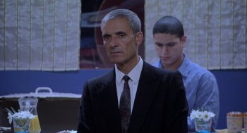 Movie still from “The Secret of the Grain” (2007), directed by Abdellatif Kechiche – An older man in a suit and a young man; Medium shot, Over the shoulder angle