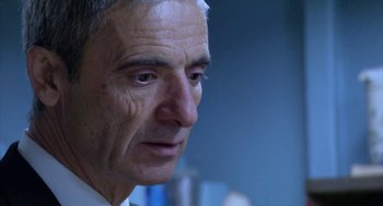 Movie still from “The Secret of the Grain” (2007), directed by Abdellatif Kechiche – An older man with grey hair looking to his left; Close Up shot, Low angle