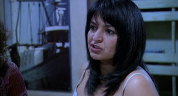 Movie still from “The Secret of the Grain” (2007), directed by Abdellatif Kechiche – A person with long black hair; Close Up shot, Over the shoulder angle