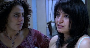 Movie still from “The Secret of the Grain” (2007), directed by Abdellatif Kechiche – Two women are looking at each other in a room; Close Up shot, Over the shoulder angle