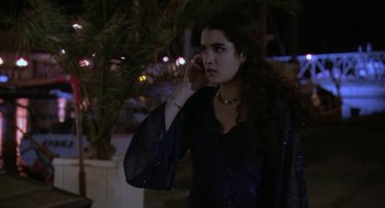 Movie still from “The Secret of the Grain” (2007), directed by Abdellatif Kechiche – A young woman talking on a cell phone outside; Medium shot, Over the shoulder angle