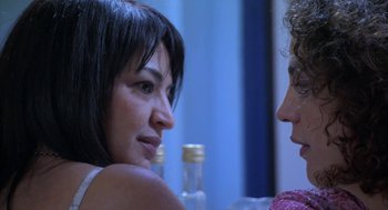 Movie still from “The Secret of the Grain” (2007), directed by Abdellatif Kechiche – Two women are talking to each other at a table; Close Up shot, Over the shoulder angle