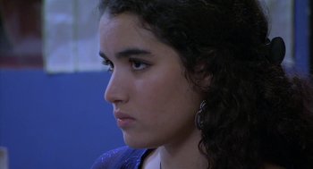 Movie still from “The Secret of the Grain” (2007), directed by Abdellatif Kechiche – A woman's face in a room; Close Up shot, Over the shoulder angle