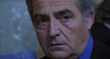 Movie still from “The Secret of the Grain” (2007), directed by Abdellatif Kechiche – An older man with blue eyes stares at the camera; Close Up shot, Over the shoulder angle