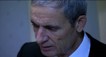 Movie still from “The Secret of the Grain” (2007), directed by Abdellatif Kechiche – An older man with grey hair looking down; Close Up shot, High angle