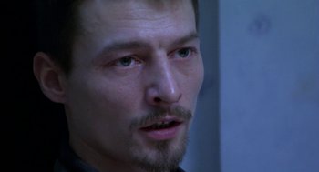 Movie still from “The Secret of the Grain” (2007), directed by Abdellatif Kechiche – A person with a beard; Close Up shot, Over the shoulder angle