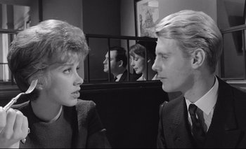 Movie still from “The Servant” (1963), directed by Joseph Losey – A man and a woman in front of each other in front of a mirror; Close Up shot, Over the shoulder angle