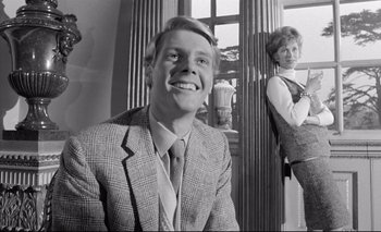 Movie still from “The Servant” (1963), directed by Joseph Losey – A black and white photo of a man and a woman; Medium shot, Low angle