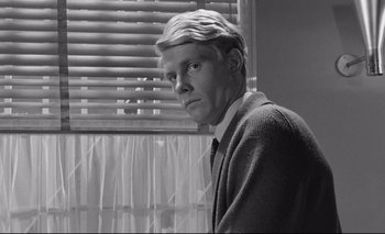 Movie still from “The Servant” (1963), directed by Joseph Losey – Black and white photograph of a man in front of a window; Close Up shot, Low angle
