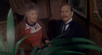 Movie still from “The Seven-Per-Cent Solution” (1976), directed by Herbert Ross – An older woman standing next to an older man; Medium shot, Over the shoulder angle