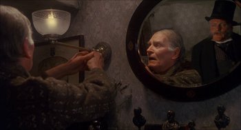 Movie still from “The Seven-Per-Cent Solution” (1976), directed by Herbert Ross – An old man is reflected in a mirror; Close Up shot, Over the shoulder angle