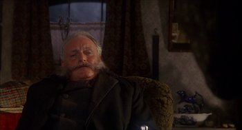 Movie still from “The Seven-Per-Cent Solution” (1976), directed by Herbert Ross – An old man with a beard and mustache sitting in a chair; Close Up shot, Low angle