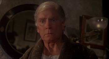 Movie still from “The Seven-Per-Cent Solution” (1976), directed by Herbert Ross – An older man with a white beard looking at the camera; Close Up shot, Low angle