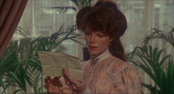 Movie still from “The Seven-Per-Cent Solution” (1976), directed by Herbert Ross – A woman holding a piece of paper while looking at it; Close Up shot, Over the shoulder angle