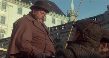 Movie still from “The Seven-Per-Cent Solution” (1976), directed by Herbert Ross – A man and a woman are sitting in a carriage; Medium shot, Low angle