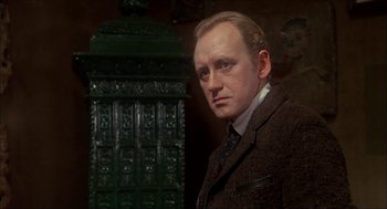 Movie still from “The Seven-Per-Cent Solution” (1976), directed by Herbert Ross – A person wearing a suit and tie; Close Up shot, Low angle