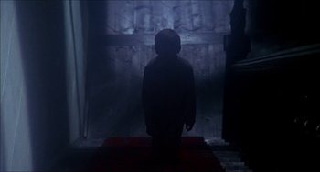 Movie still from “The Seven-Per-Cent Solution” (1976), directed by Herbert Ross – A person standing in the dark in front of a building; Wide shot, Low angle