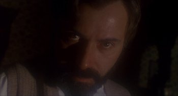 Movie still from “The Seven-Per-Cent Solution” (1976), directed by Herbert Ross – A person with a beard looking at the camera; Close Up shot, Low angle