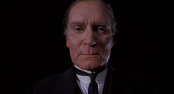 Movie still from “The Seven-Per-Cent Solution” (1976), directed by Herbert Ross – An older man wearing a suit and a tie; Close Up shot, Low angle