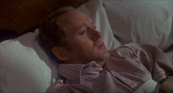 Movie still from “The Seven-Per-Cent Solution” (1976), directed by Herbert Ross – A person laying in a bed; Close Up shot, High angle