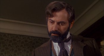 Movie still from “The Seven-Per-Cent Solution” (1976), directed by Herbert Ross – A man in a suit and a tie looking to his left; Close Up shot, Low angle