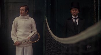 Movie still from “The Seven-Per-Cent Solution” (1976), directed by Herbert Ross – Two men in suits and hats holding rackets; Medium shot, Low angle