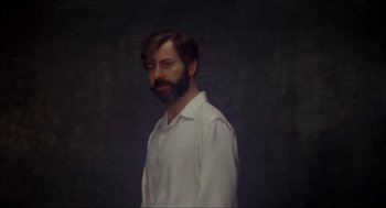 Movie still from “The Seven-Per-Cent Solution” (1976), directed by Herbert Ross – A man with a beard and a white shirt; Close Up shot, Low angle