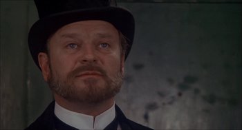 Movie still from “The Seven-Per-Cent Solution” (1976), directed by Herbert Ross – A person wearing a top hat; Close Up shot, Low angle