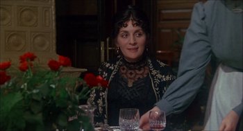 Movie still from “The Seven-Per-Cent Solution” (1976), directed by Herbert Ross – A woman sitting at a table with a glass of wine in front of her; Close Up shot, Over the shoulder angle