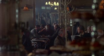 Movie still from “The Seven-Per-Cent Solution” (1976), directed by Herbert Ross – A group of people sitting at a table in a restaurant; Wide shot, Over the shoulder angle