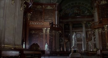 Movie still from “The Seven-Per-Cent Solution” (1976), directed by Herbert Ross – A room filled with lots of books and statues; Extreme Wide shot, Low angle
