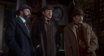 Movie still from “The Seven-Per-Cent Solution” (1976), directed by Herbert Ross – A group of men standing next to each other wearing hats; Medium shot, Low angle