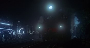 Movie still from “The Seven-Per-Cent Solution” (1976), directed by Herbert Ross – A train on a train track at night time; Extreme Wide shot, Low angle