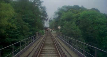 Movie still from “The Seven-Per-Cent Solution” (1976), directed by Herbert Ross – A view of train tracks with trees in the background; Extreme Wide shot, High angle