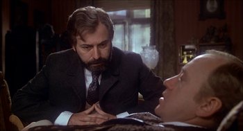 Movie still from “The Seven-Per-Cent Solution” (1976), directed by Herbert Ross – A man in a suit talking to another man in a suit and tie; Close Up shot, Over the shoulder angle