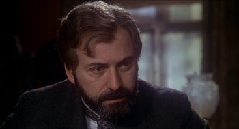 Movie still from “The Seven-Per-Cent Solution” (1976), directed by Herbert Ross – A person wearing a suit and tie; Close Up shot, Over the shoulder angle