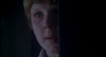 Movie still from “The Seven-Per-Cent Solution” (1976), directed by Herbert Ross – A child's face in a dark room; Close Up shot, Low angle