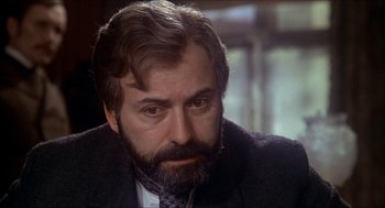 Movie still from “The Seven-Per-Cent Solution” (1976), directed by Herbert Ross – A person wearing a suit and tie; Close Up shot, Over the shoulder angle