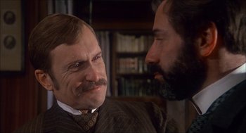Movie still from “The Seven-Per-Cent Solution” (1976), directed by Herbert Ross – A man with a mustache and a beard talking to another man with a mustache and a beard; Close Up shot, Over the shoulder angle