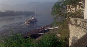 Movie still from “The Seven-Per-Cent Solution” (1976), directed by Herbert Ross – A boat traveling down a river next to a bridge; Extreme Wide shot, High angle