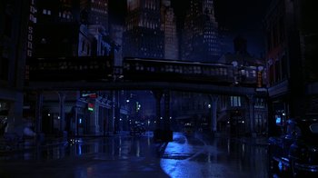 Movie still from “The Shadow” (1994), directed by Russell Mulcahy – A city at night lit up by streetlights; Extreme Wide shot, High angle
