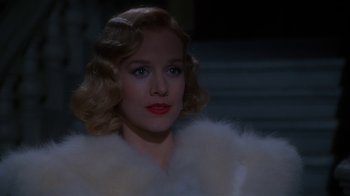 Movie still from “The Shadow” (1994), directed by Russell Mulcahy – A person wearing a fur coat; Close Up shot, Over the shoulder angle