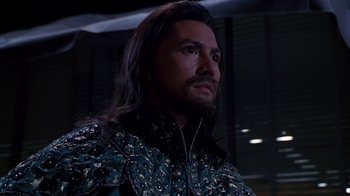 Movie still from “The Shadow” (1994), directed by Russell Mulcahy – A person with long black hair; Close Up shot, Low angle