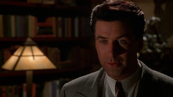 Movie still from “The Shadow” (1994), directed by Russell Mulcahy – A person wearing a suit and tie; Close Up shot, Low angle